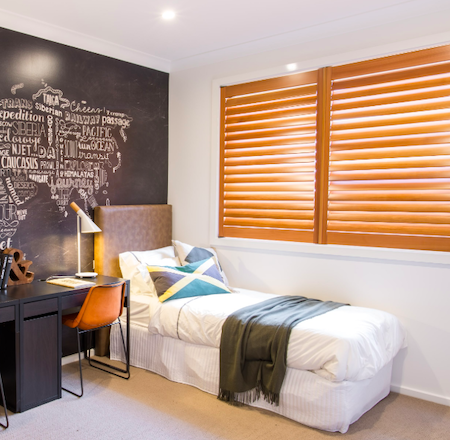 natural look timber shutters in a bedroom