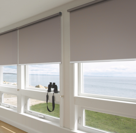 blockout blinds in a lounge conservatory with a seaside view