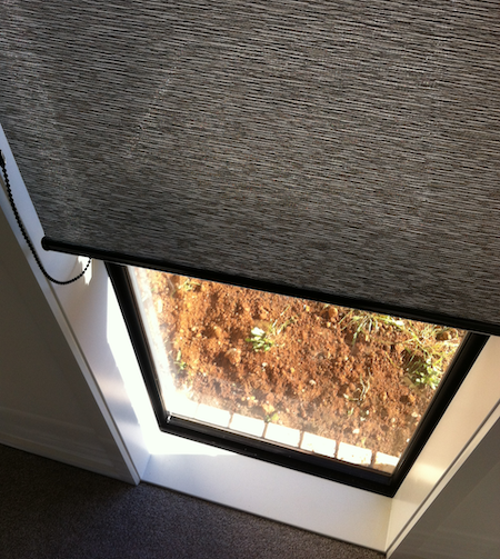 sheer roller blinds in a window space of a new home