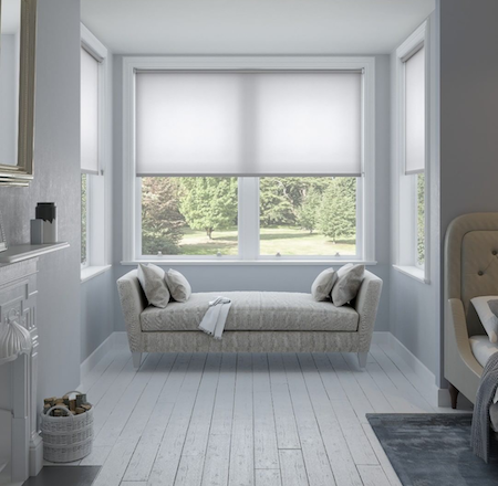 sheer roller blinds in bay window area of a home