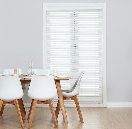 wooden blinds over french doors in a dining room