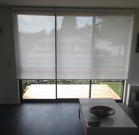 sunscreen blinds over a sliding door in a homes lounge area