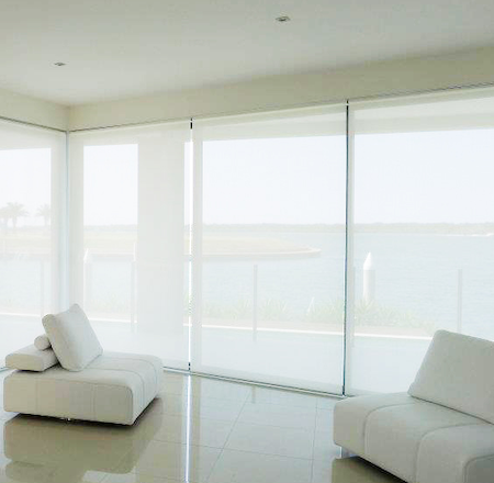 sunscreen blinds providing privacy and uv protection in a lounge with a view