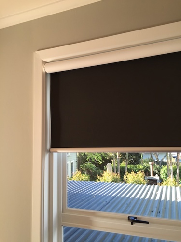 Back-rolled blockout roller blind with white backing visible along the top of the roll